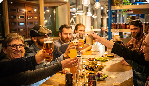People enjoying RABAUW beers at a bar
